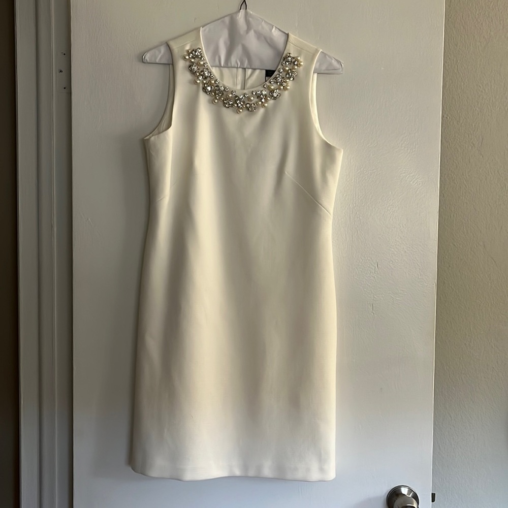 Elegant White Sleeveless Dress with Embellished Neckline